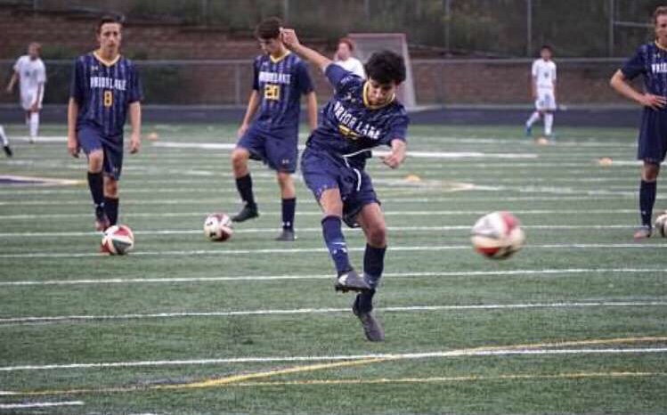 The Prior Lake boys varsity soccer team warming up before a game.