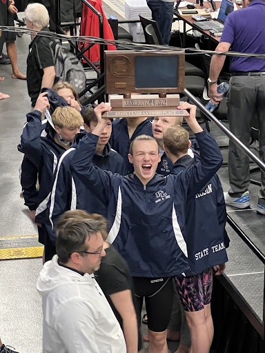 Jackson Stout holding the 3rd place MSHSL Class AA Boys Swimming and Diving Award