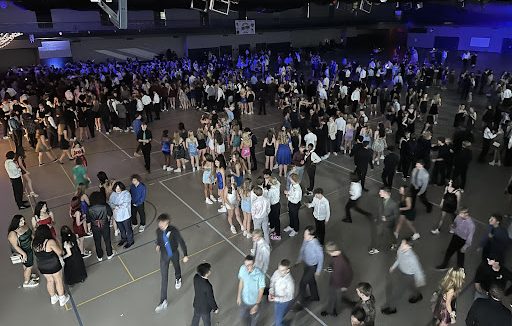 The Homecoming dance in full bloom. Bustling students roaming the Activity Center with their formal attire as they enjoy the night full of fun, music, and dancing